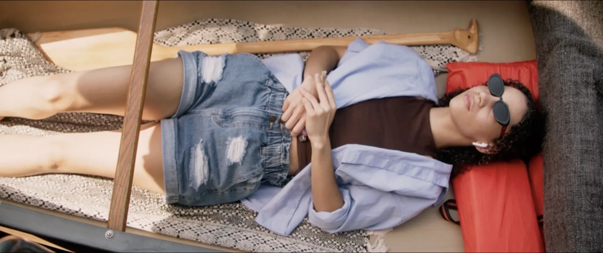 A woman resting in a canoe, seen from above